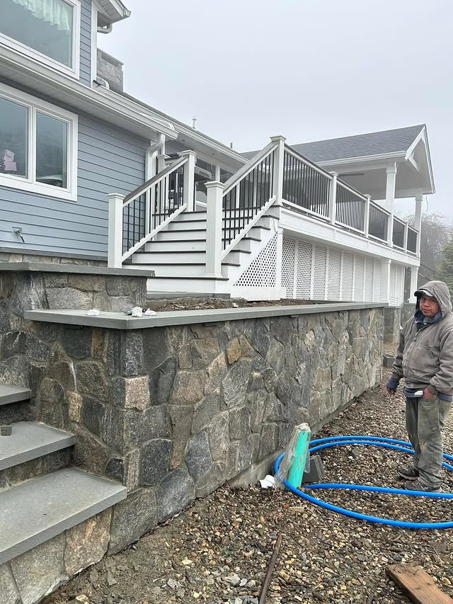 Exterior stone veneer wall under elevated deck